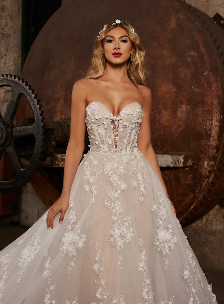 close up of calla blanche nude tulle a-line wedding dress with floral laces throughout and a sweetheart neckline