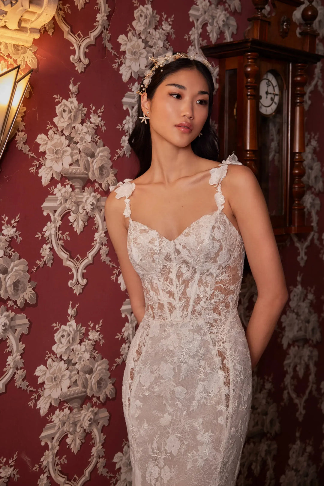 close up of calla blanche flo ivory lace fitted wedding dress with a sweetheart neckline and floral lace straps