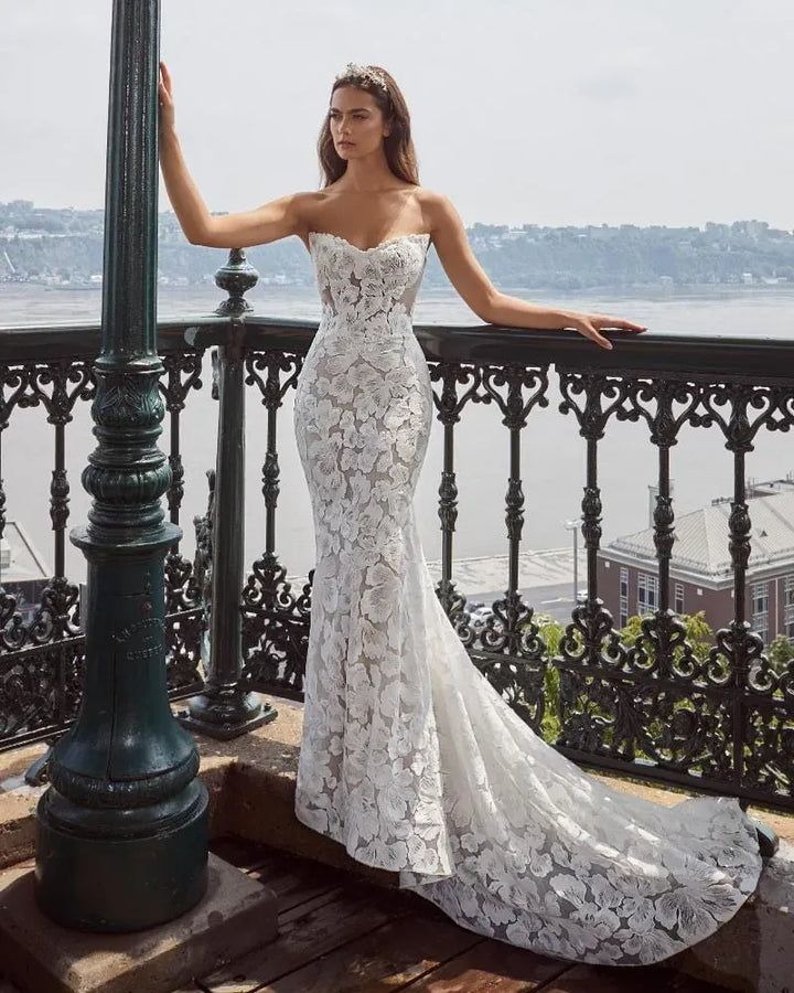 front of calla blanche jill lace fitted wedding dress featuring oversized floral laces and a pointed v neckline