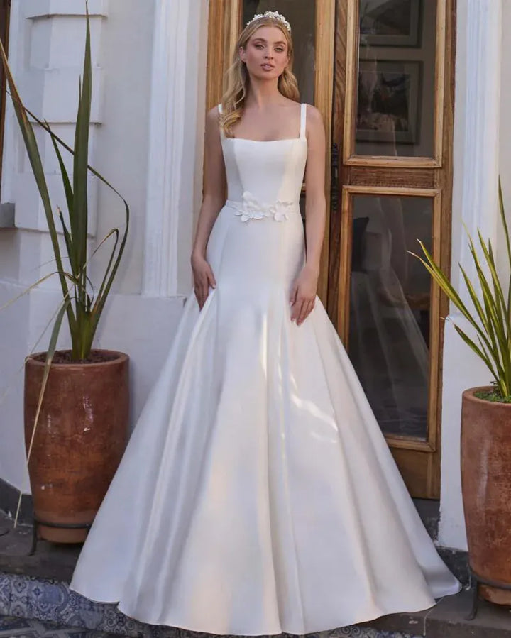 full front of calla blanche karissa ivory satin fit and flare wedding dress with a matching belt and square neckline