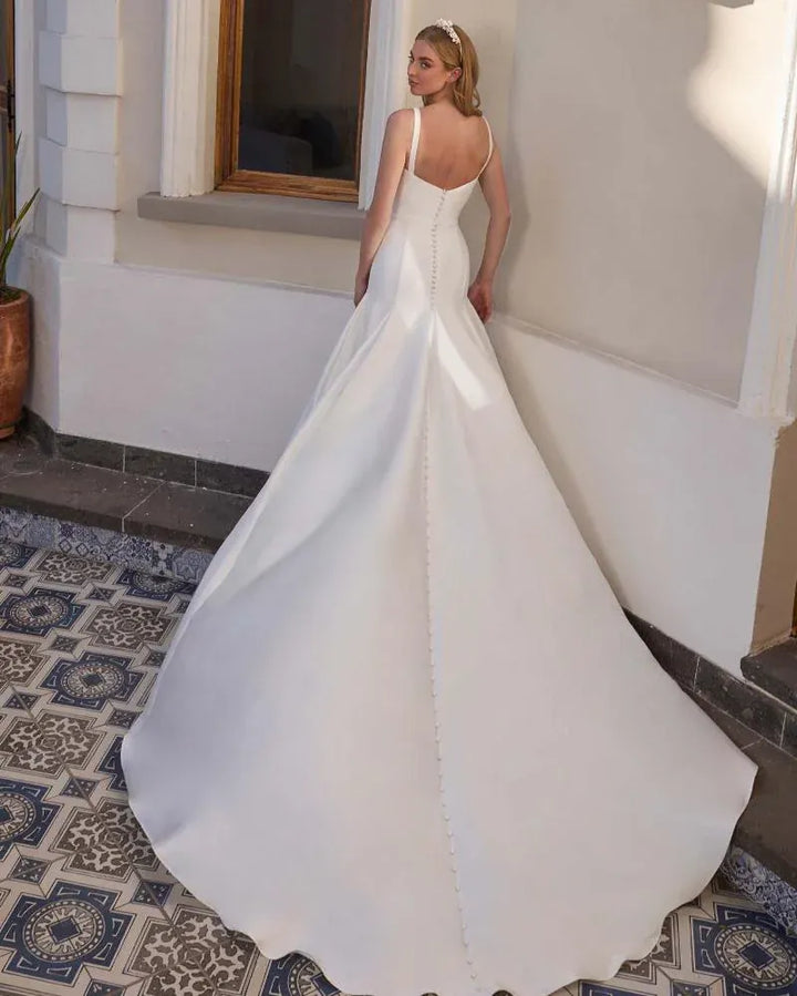 full back of calla blanche karissa ivory satin fit and flare wedding dress with a matching belt and chapel length train