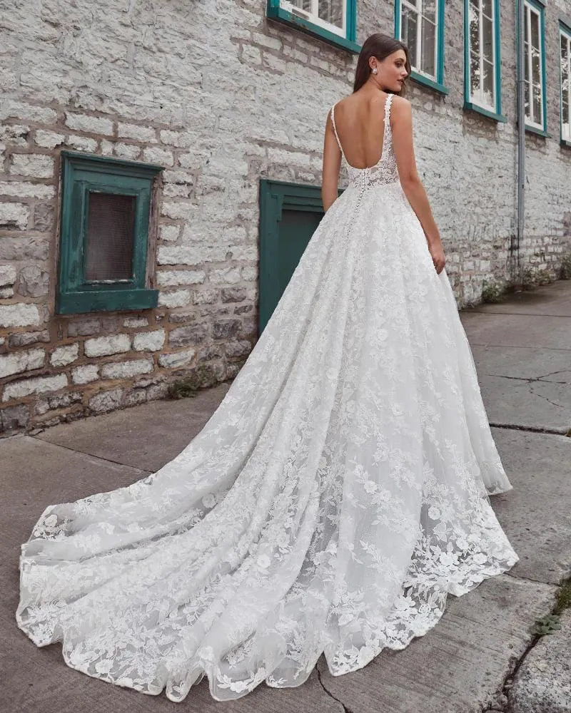 Woman wearing a white lace wedding dress in an urban setting.