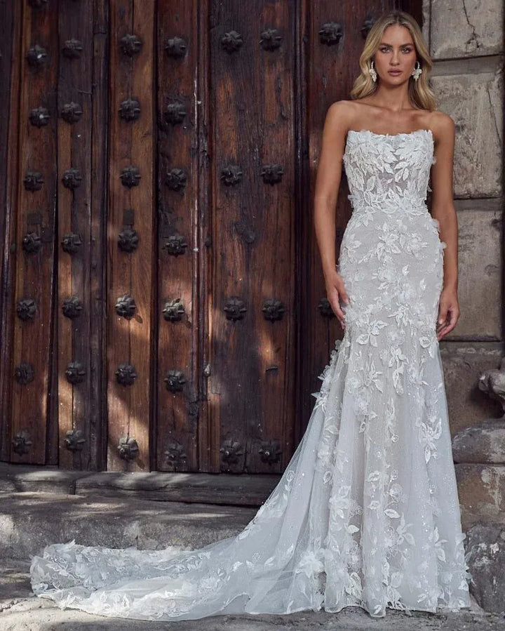 front of calla blanche monica ivory lace fit and flare wedding dress with a semi sheer bodice and strapless neckline