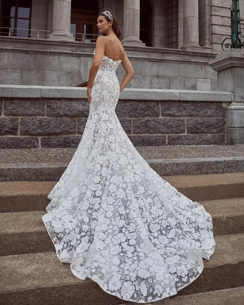 back of calla blanche nailah nude colord lace fit and flare wedding dress with a chapel length train at the back