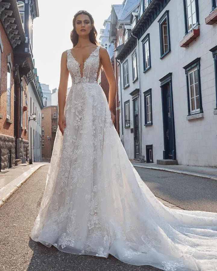 front of calla blanche roxy champagne tulle a-line wedding dress with allover lace and a deep v neckline