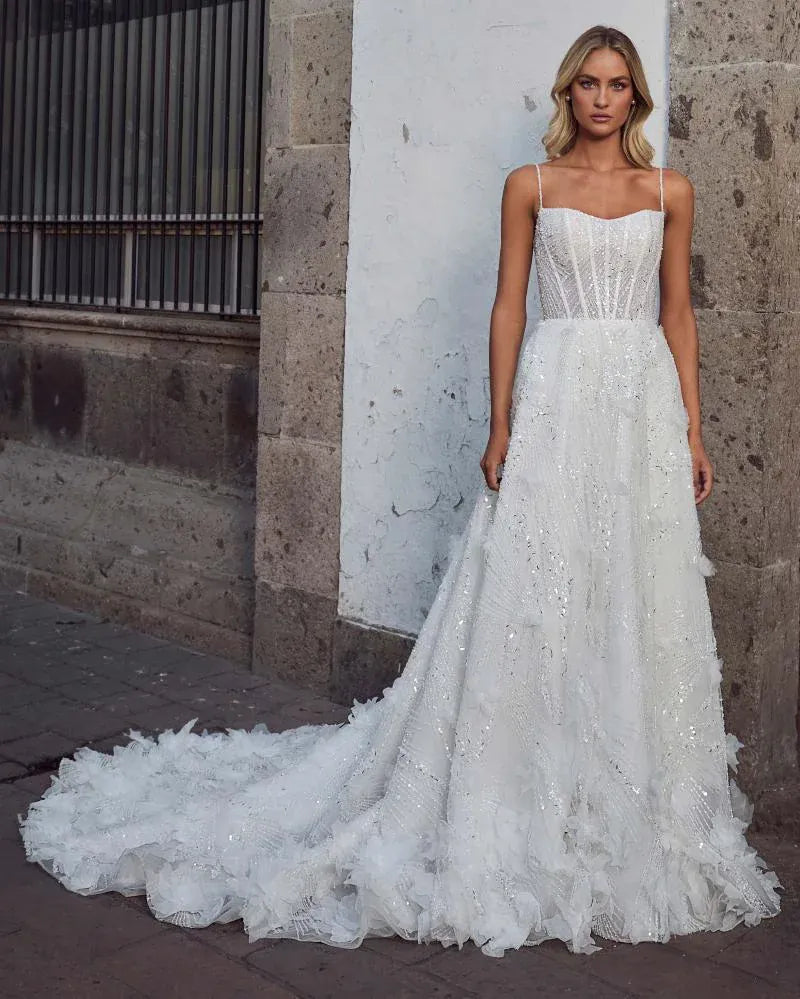 front of calla blanche selva ivory beaded a-line wedding dress with beading and dimensional accents on the skirt and train