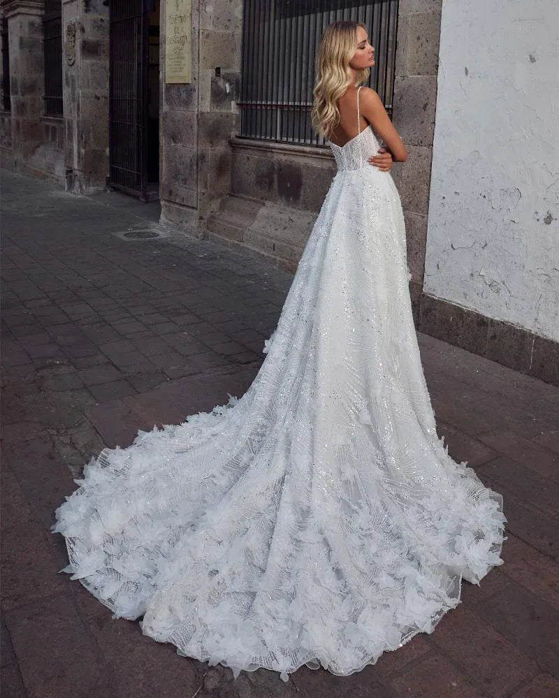 back of calla blanche selva ivory beaded a-line wedding dress with beading and dimensional accents on the skirt and train
