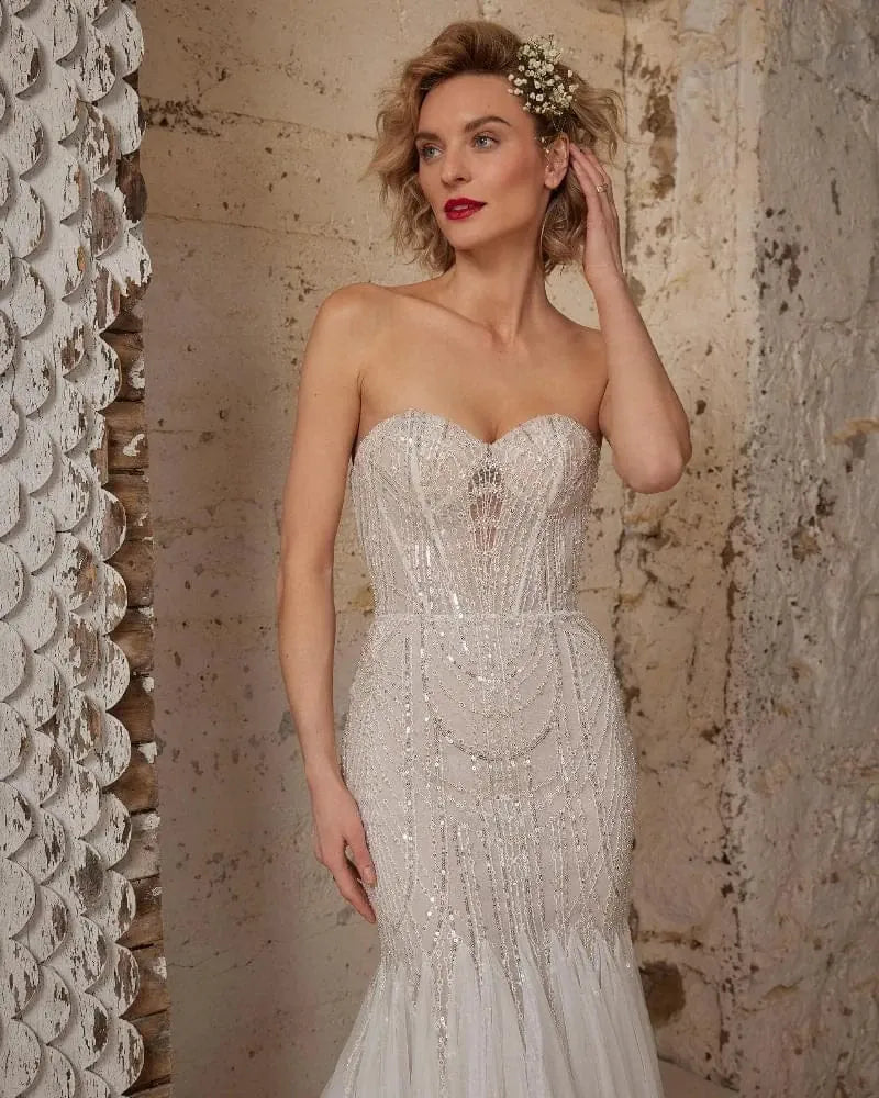 close up of calla blanche wednesday champagne tulle fit and flare wedding dress showing the beaded bodice