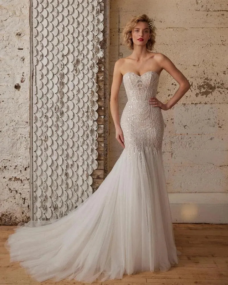 front of calla blanche wednesday champagne tulle fit and flare wedding dress with beaded bodice and strapless sweetheart neckline
