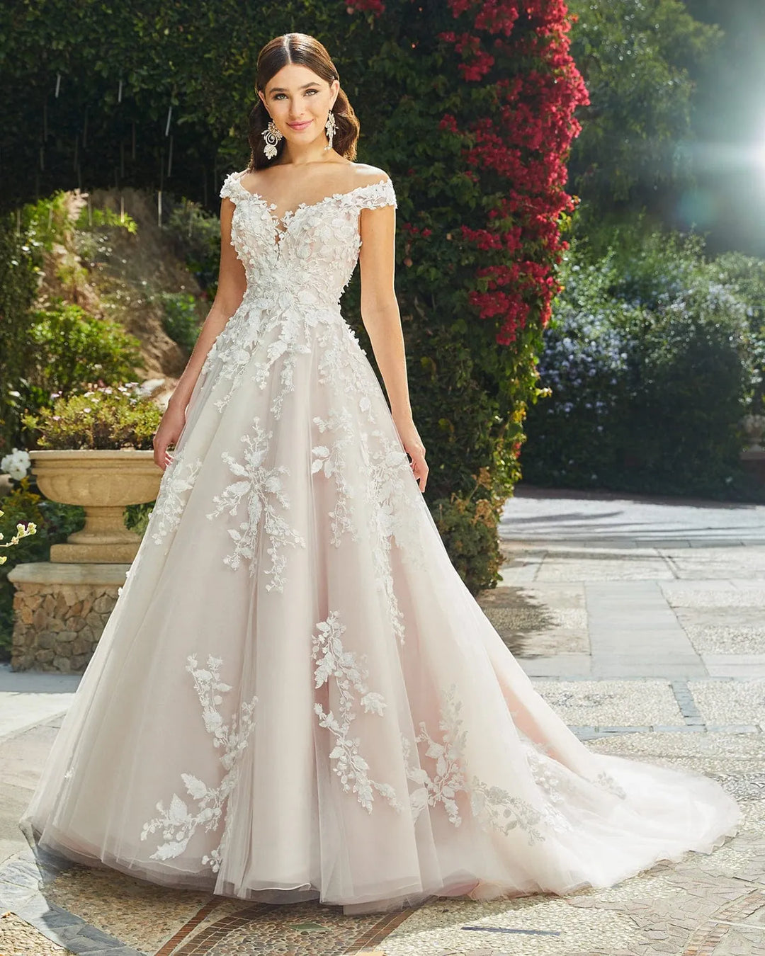 full front of casablanca 2406 blush tulle ball gown wedding dress with lace appliques and an off the shoulder neckline