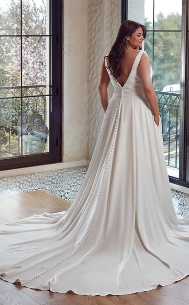 full back of eddy k addison ivory crepe a-line wedding dress with a v back and beaded accents at the waist