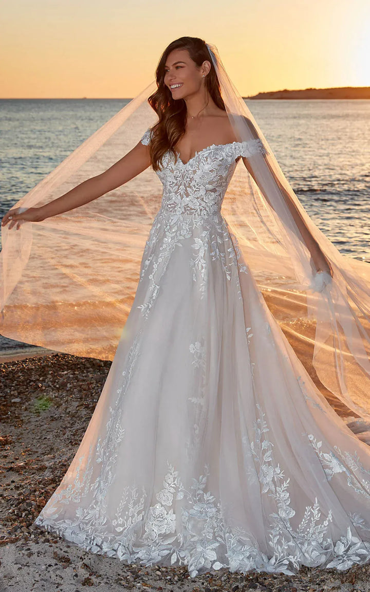 full front of eddy k dr2301 ivory tulle a-line wedding dress with scattered lace appliques and an off the shoulder neckline