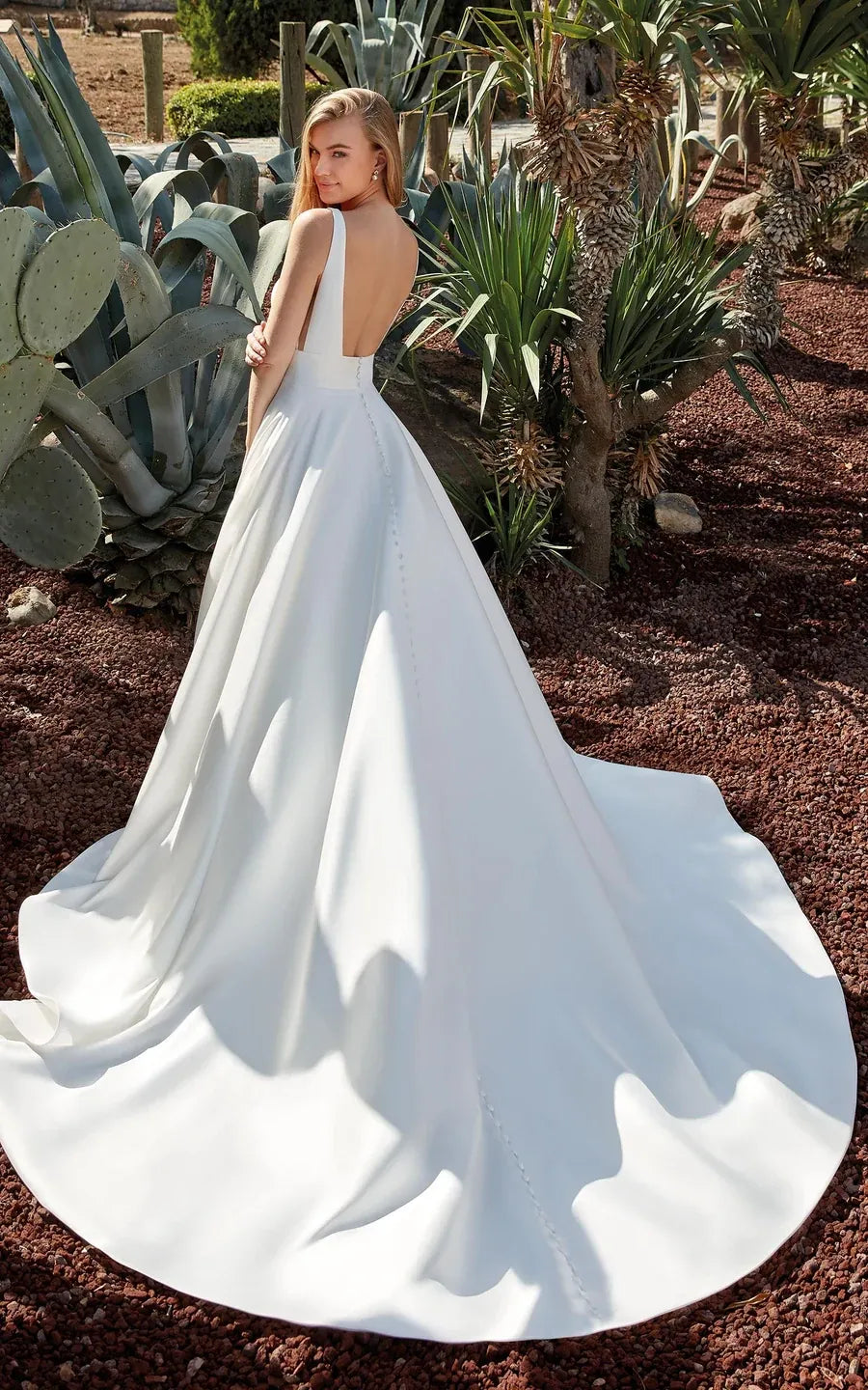 full back of eddy k becca ivory mikado ball gown wedding dress with a deep v neckline and chapel length train