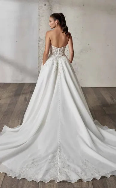 full back of eddy k loretta organza ball gown with a strapless beaded bodice and a chapel length train