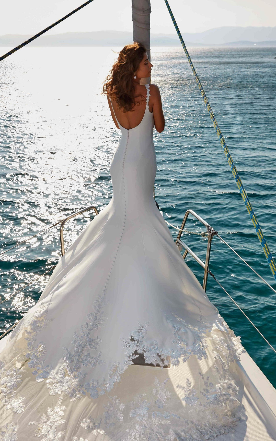 full back of eddy k nikita ivory crepe sheath wedding dress with lace details throughout, and on the long lace train