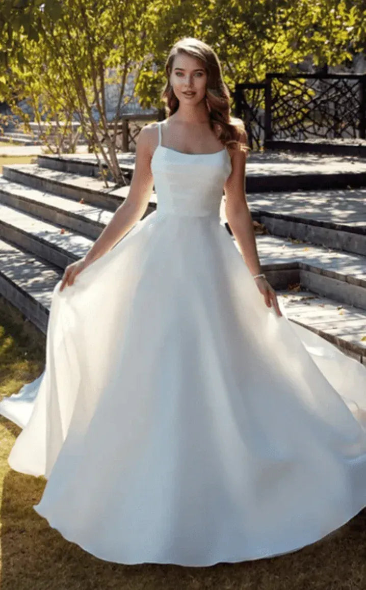 full front of eddy k chrissy nude organza a-line wedding dress with a scoop neckline and thin straps