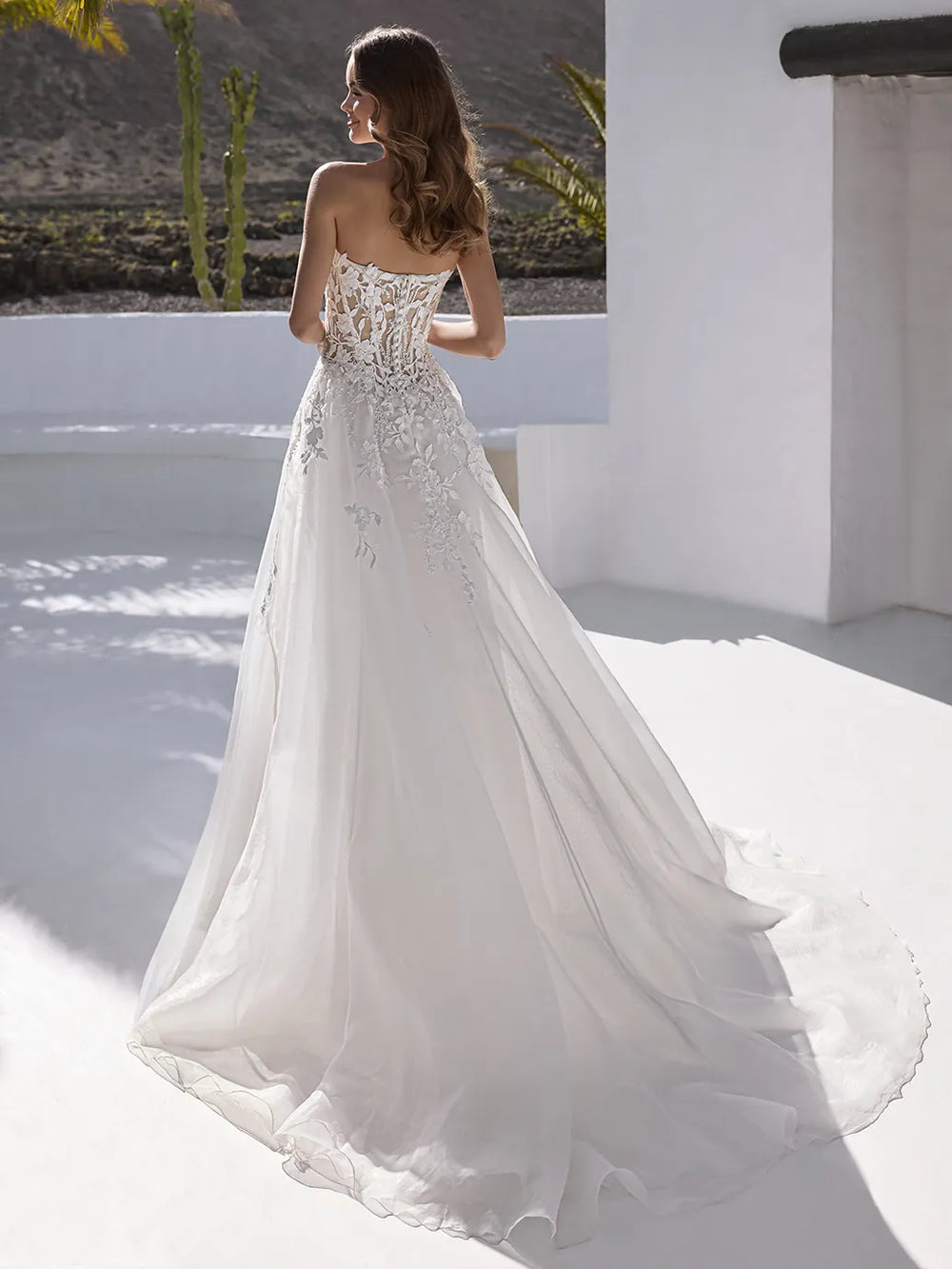 back of enzoani everly ivory organza a-line wedding dress showing the full back, with a chapel length train