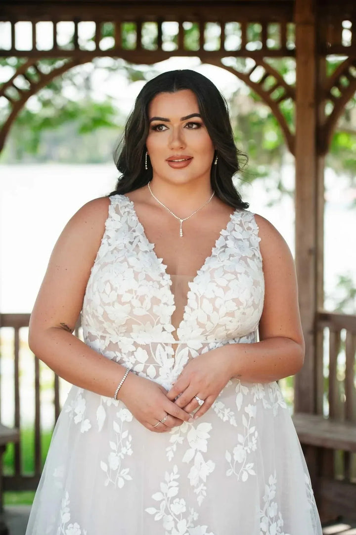 close up of essense d3783 champagne tulle a-line wedding dresswith scattered floral lace appliques and a deep v neckline