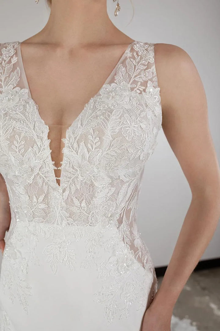 Close-up of a white lace wedding dress with a deep neckline.