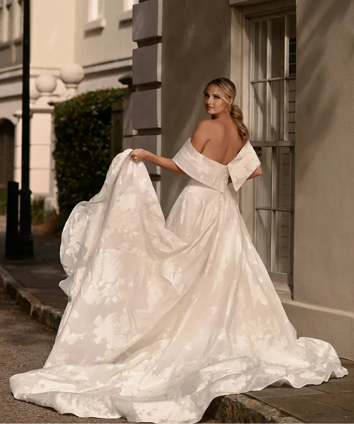 full back of essense of australia d3971 ivory jacquard ball gown with a matching off the shoulder neckline that is detachable, and a long train