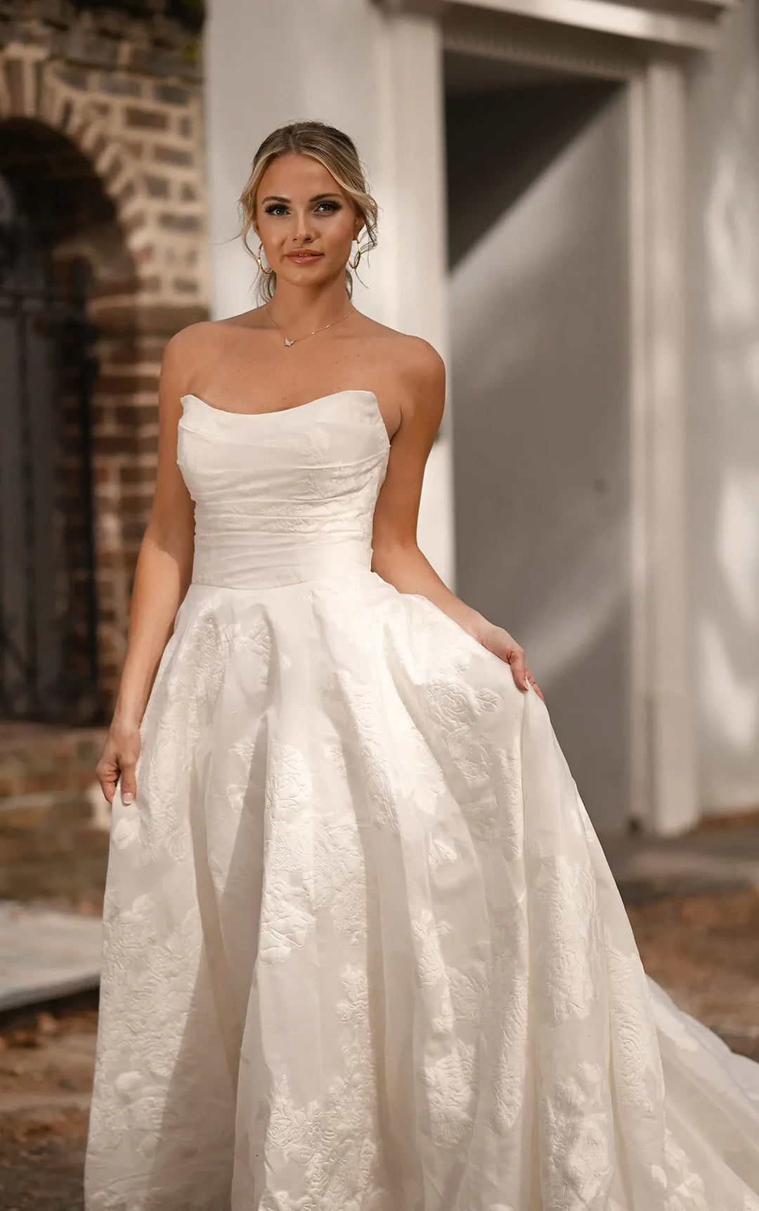 close up of essense of australia d3971 ivory jacquard a-line wedding dress featuring a strapless scoop neckline