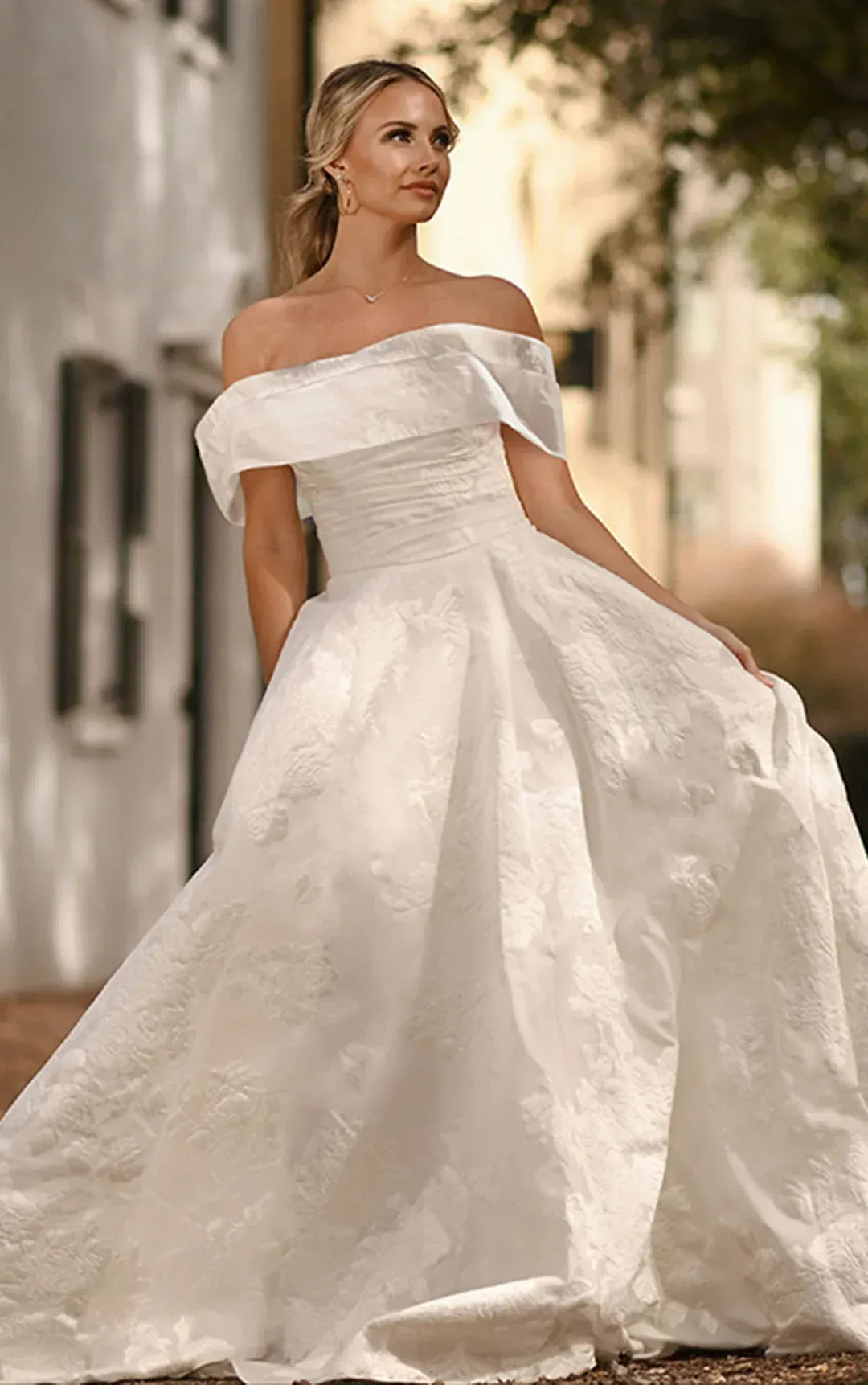 full front of essense of australia d3971 ivory jacquard ball gown with a matching off the shoulder neckline that is detachable