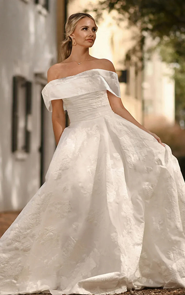 full front of essense of australia d3971 ivory jacquard ball gown with a matching off the shoulder neckline that is detachable
