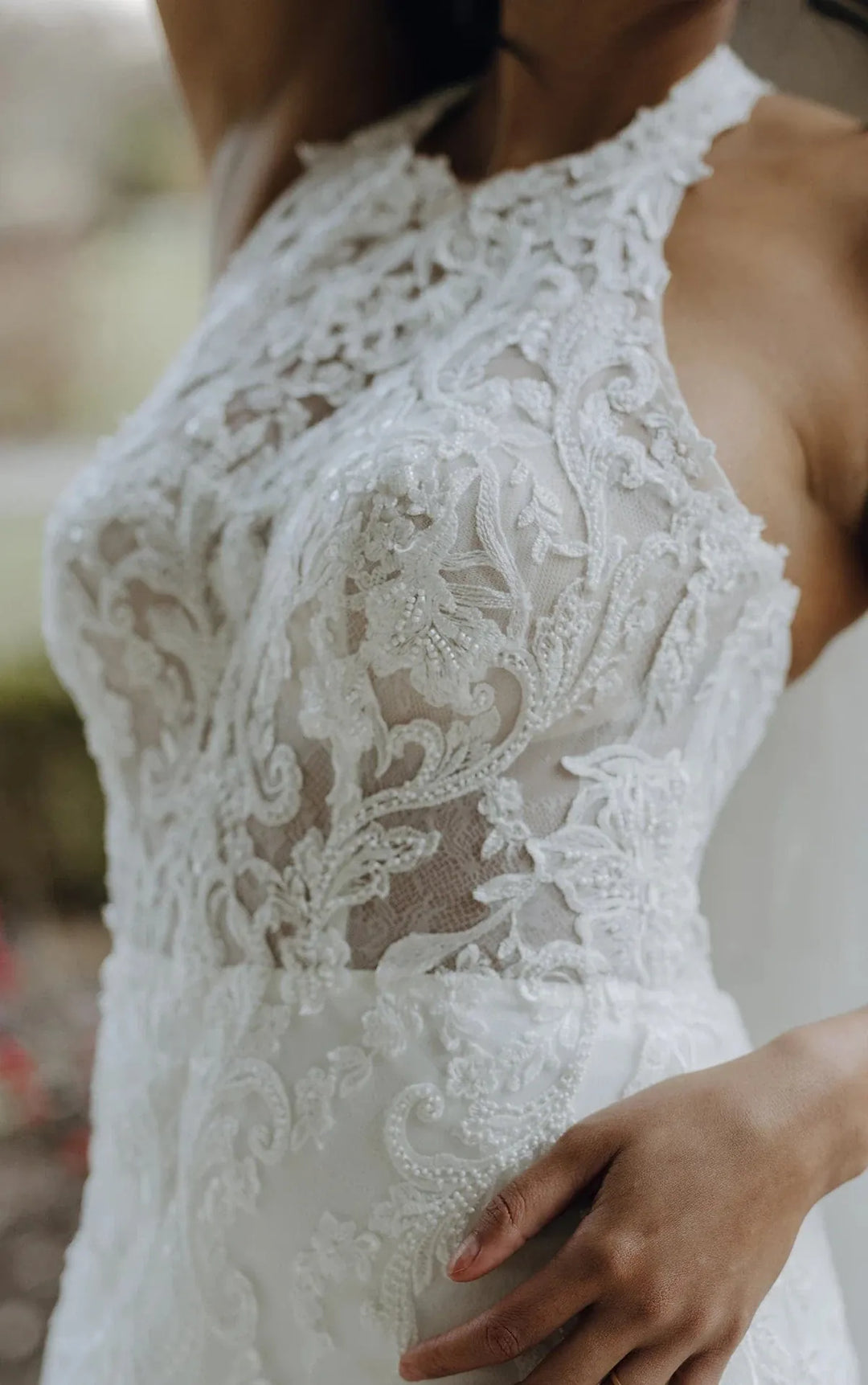 Close-up of a white lace dress with intricate detailing.