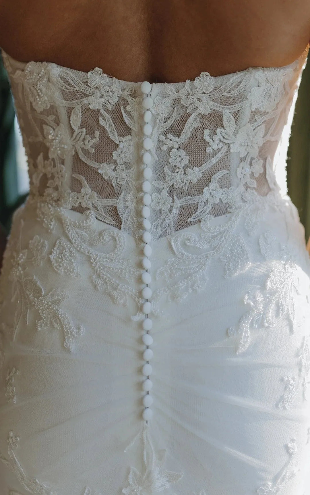 Close-up of a white lace wedding dress