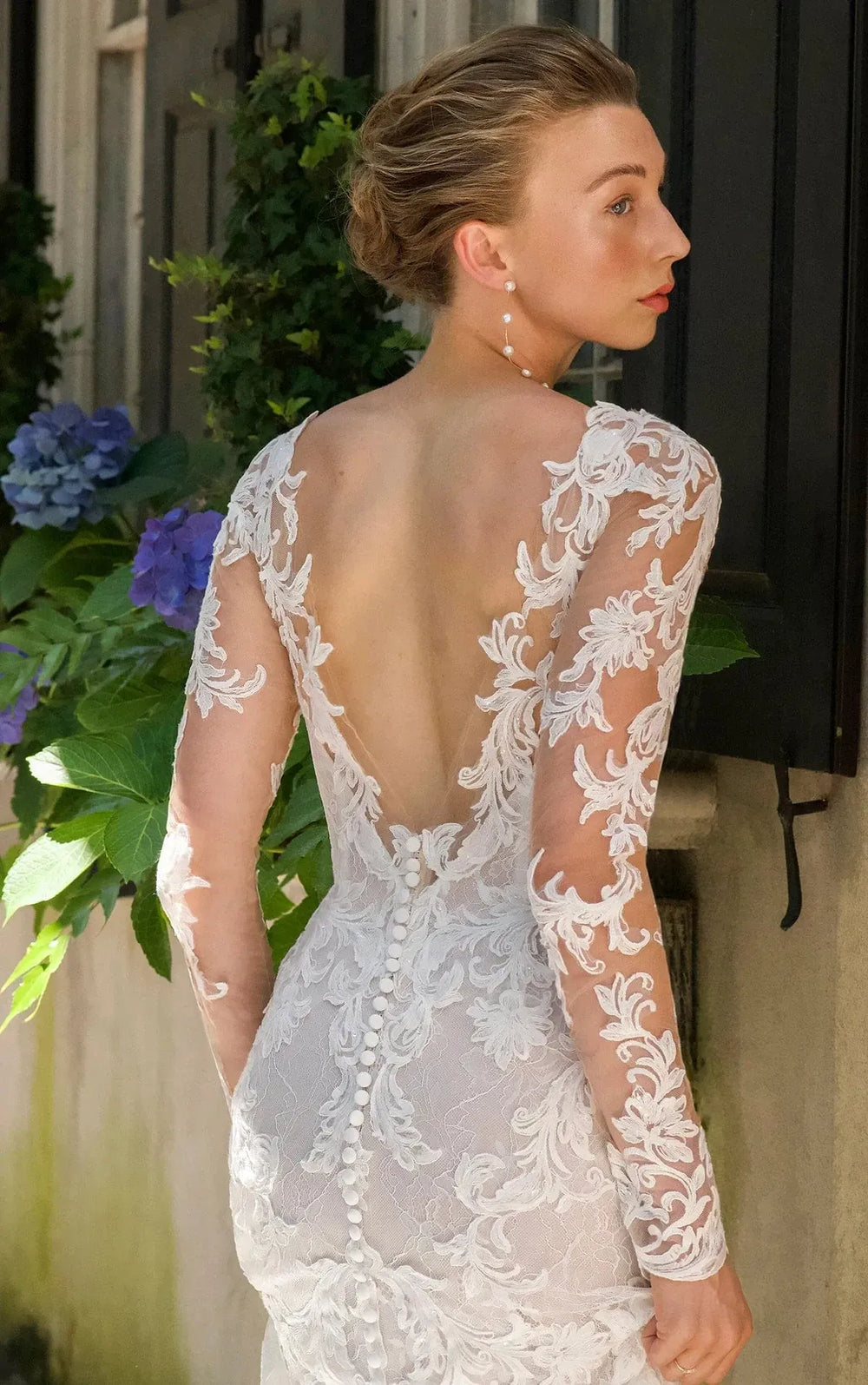 close up of essense d4172 ivory lace sheath wedding dress with long sleeves and a shaped train