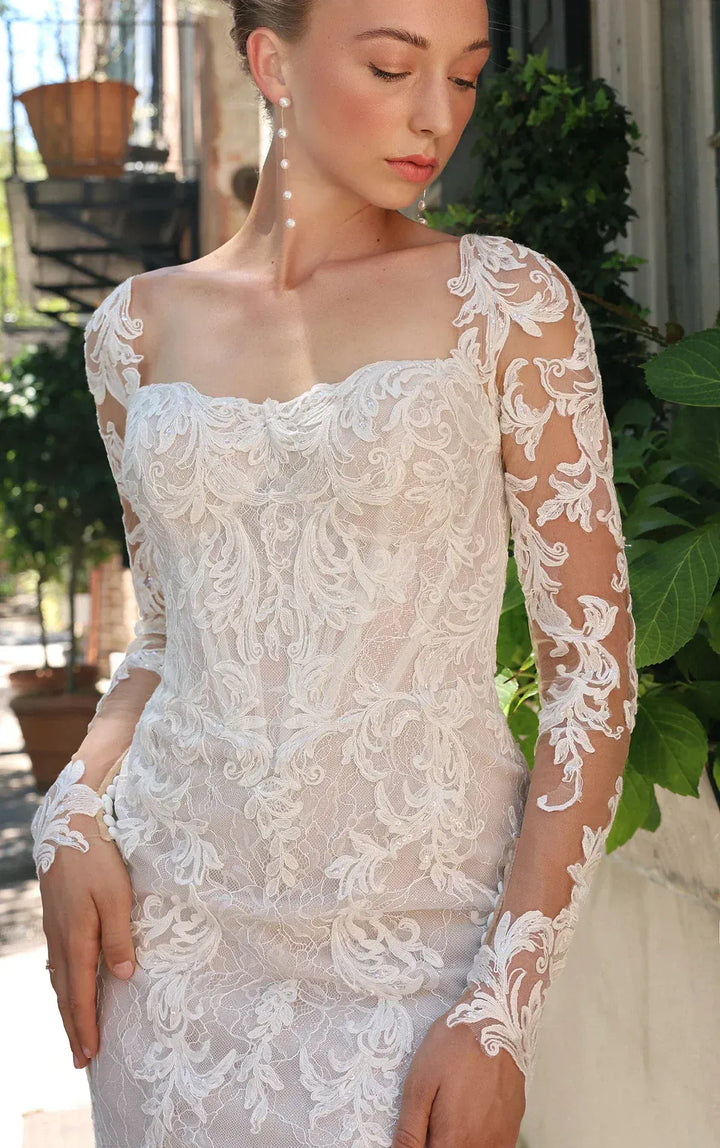 close up of essense d4172 ivory lace sheath wedding dress with long sleeves and a shaped train