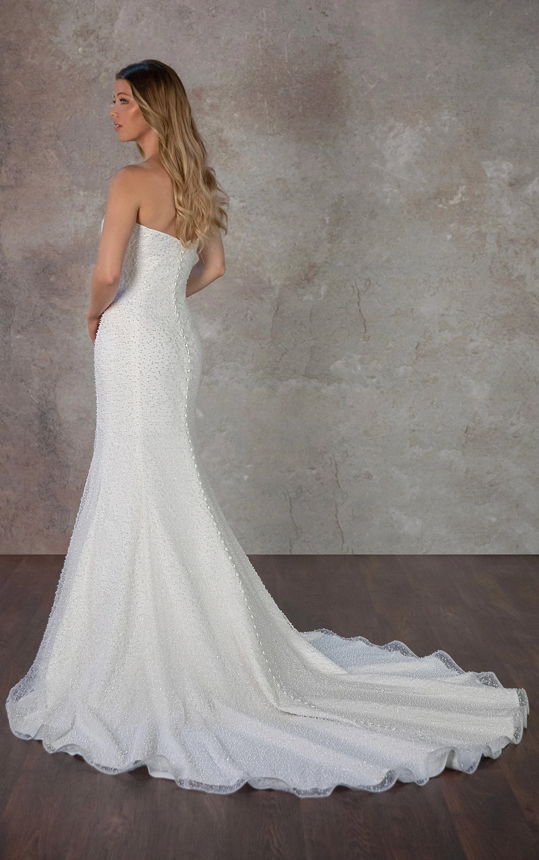 back of essense of australia d4182 ivory beaded fit and flare wedding dress with buttons down the back, and chapel length train
