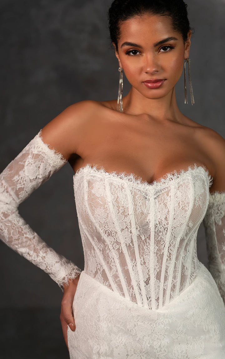 close up of essense of australia d4287 ivory lace fitted wedding dress, showing the basque waist bodice with the detached long sleeves
