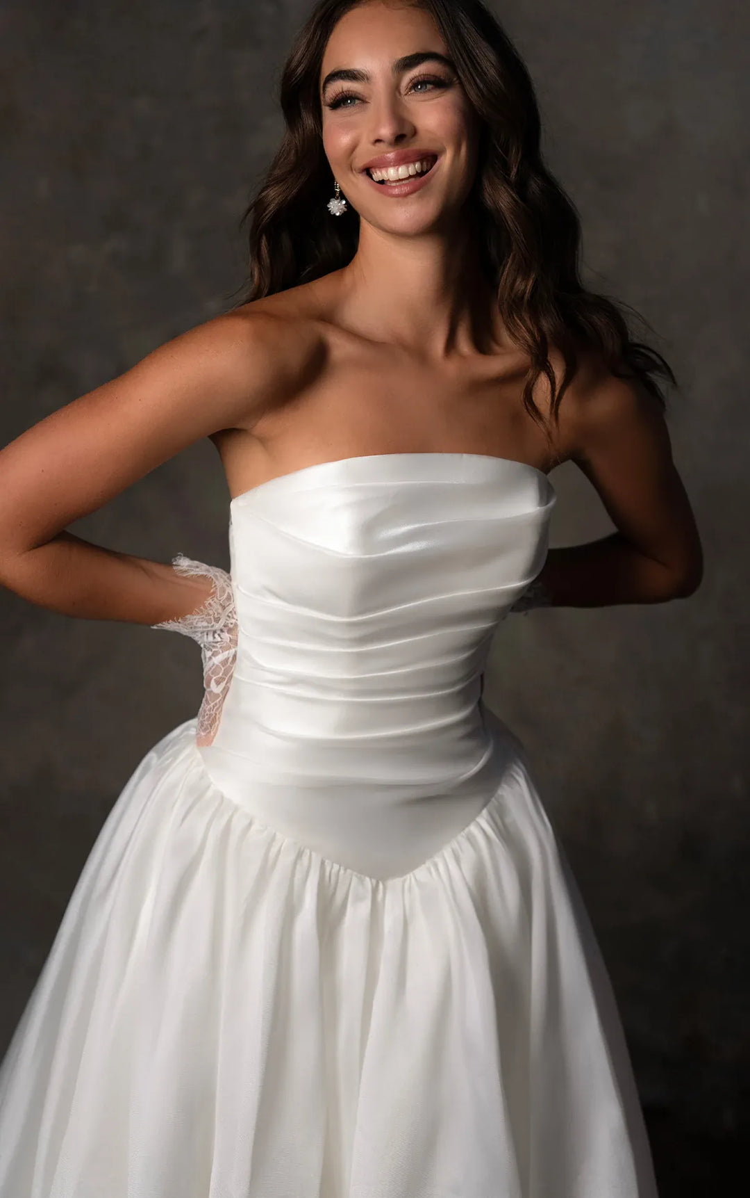 close up of essense d4454 ivory organza a-line wedding dress with a basque waist and ruched bodice