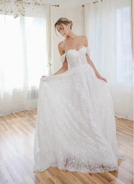 front of estee couture liv ivory sparkle tulle a-line wedding dress with a strapless sweetheart neckline