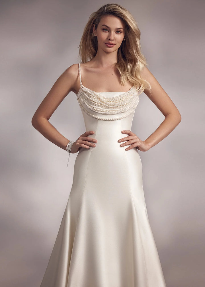 close up of eva lendel ora ivory satin fitted wedding dress showing the beaded neckline