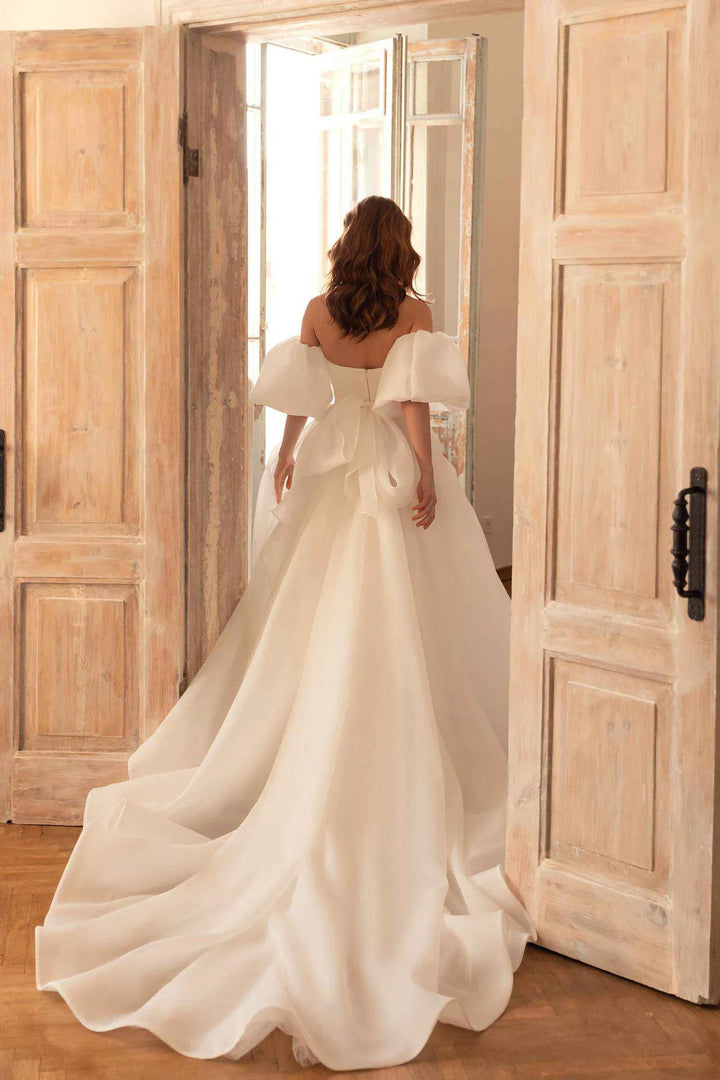 full back of eva lendel samanta ivory organza a-line wedding dress with a bow at the back, and a chapel length train