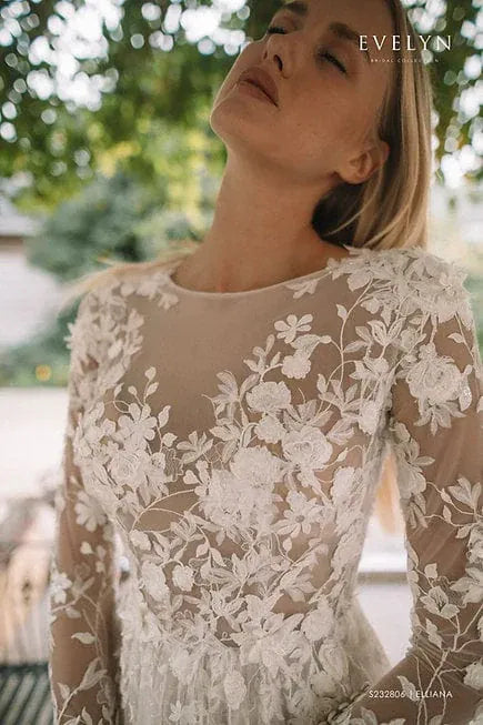 Woman wearing a floral lace dress with a blurred outdoor background