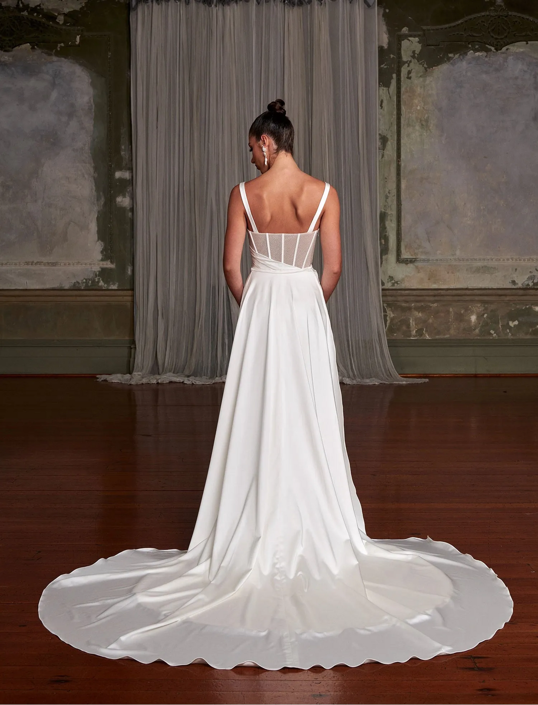 back of evie young gia ivory satin sheath wedding dress showing the detachable overskirt that creates a longer train at the back