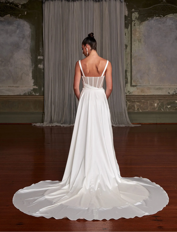 back of evie young gia ivory satin sheath wedding dress showing the detachable overskirt that creates a longer train at the back