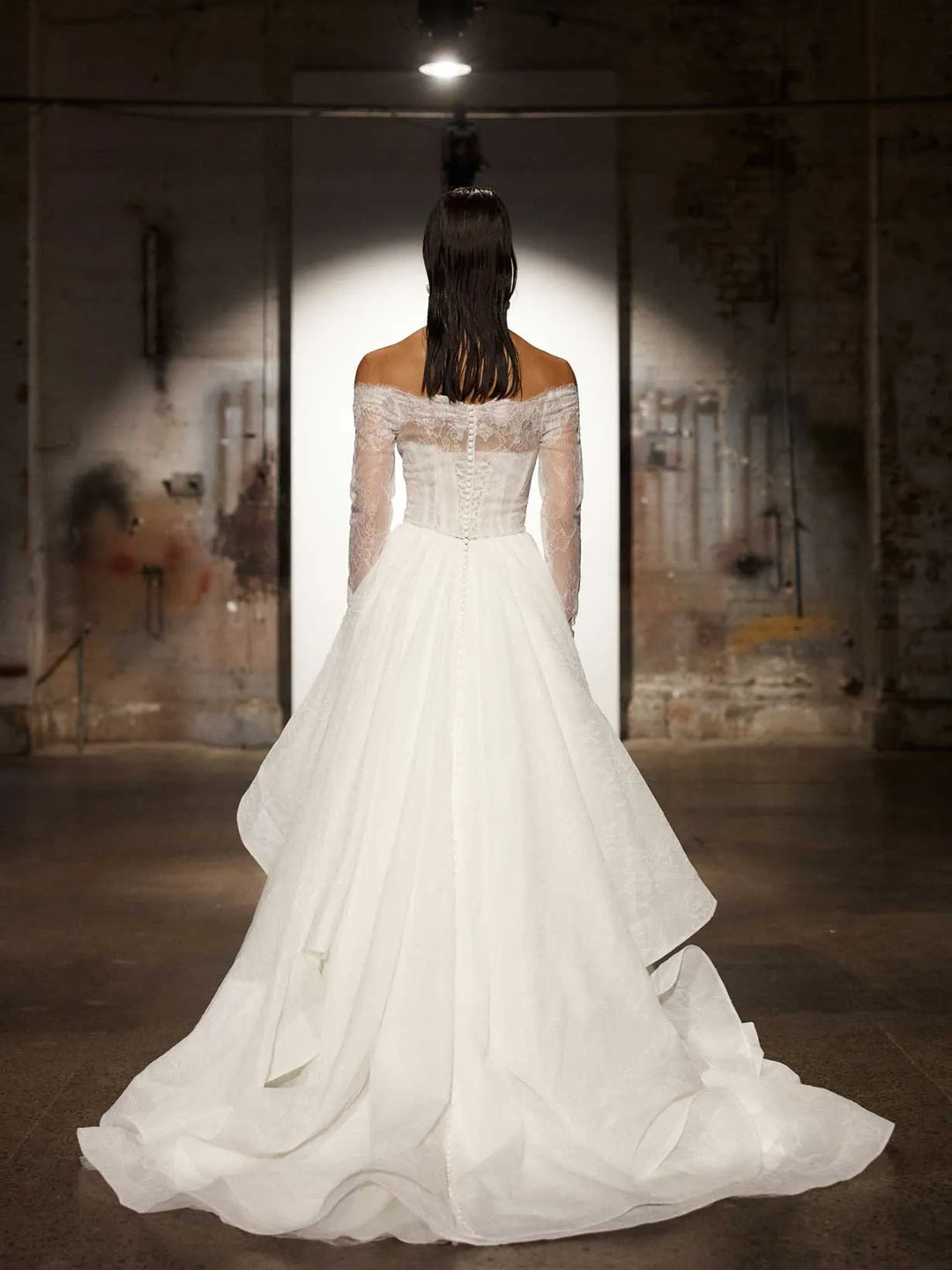 full back of evie young hollis ivory organza ball gown wedding dress with a matching long sleeve lace jacket