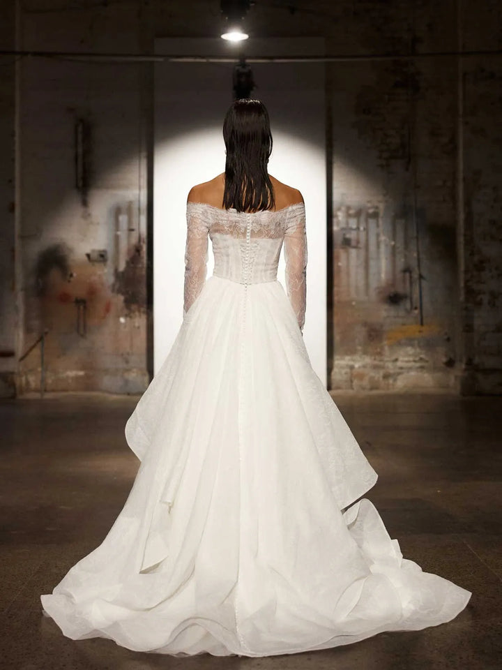 full back of evie young hollis ivory organza ball gown wedding dress with a matching long sleeve lace jacket