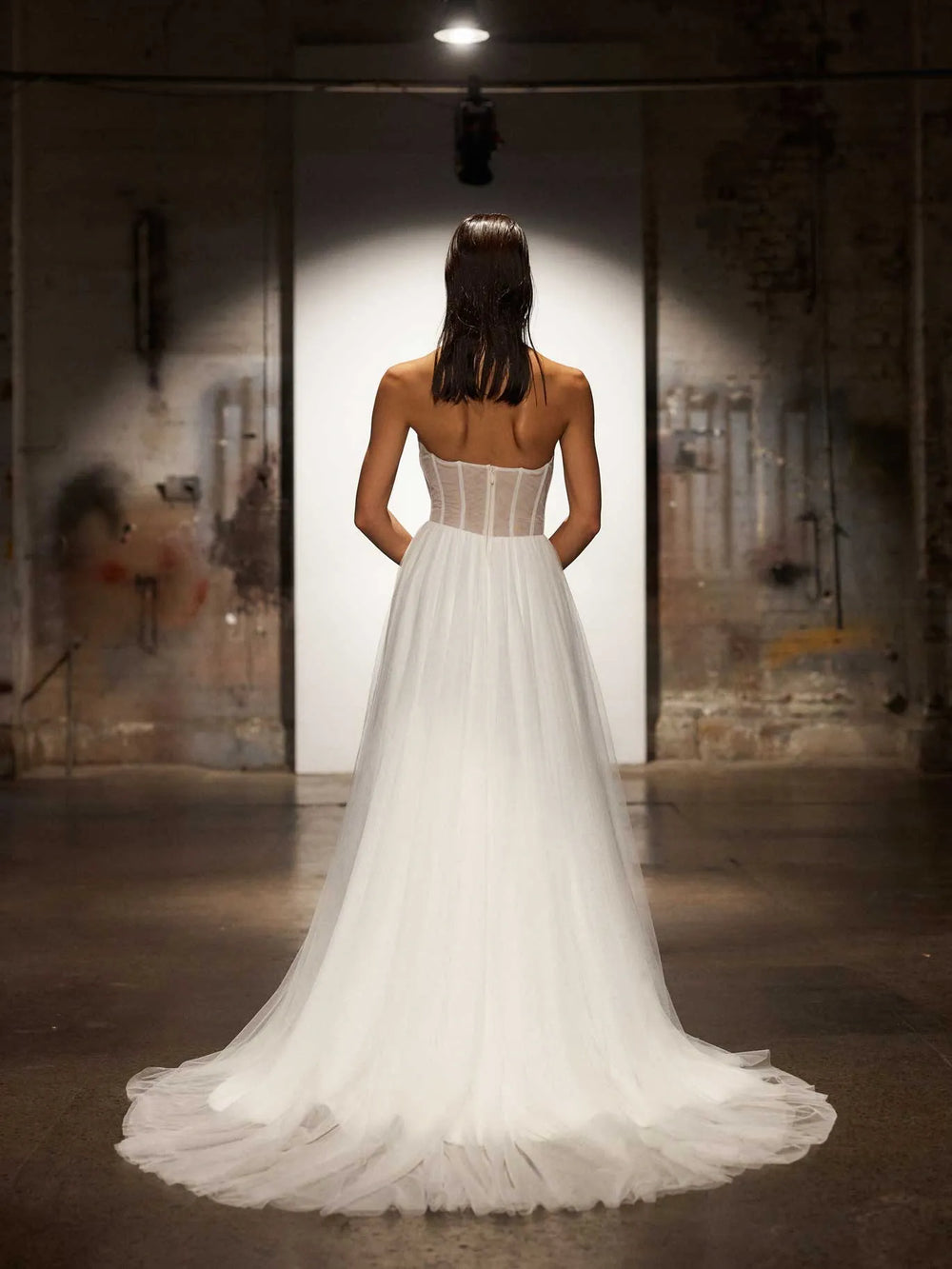 back of evie young houston tulle a-line wedding dress showing the sheer back and chapel length train