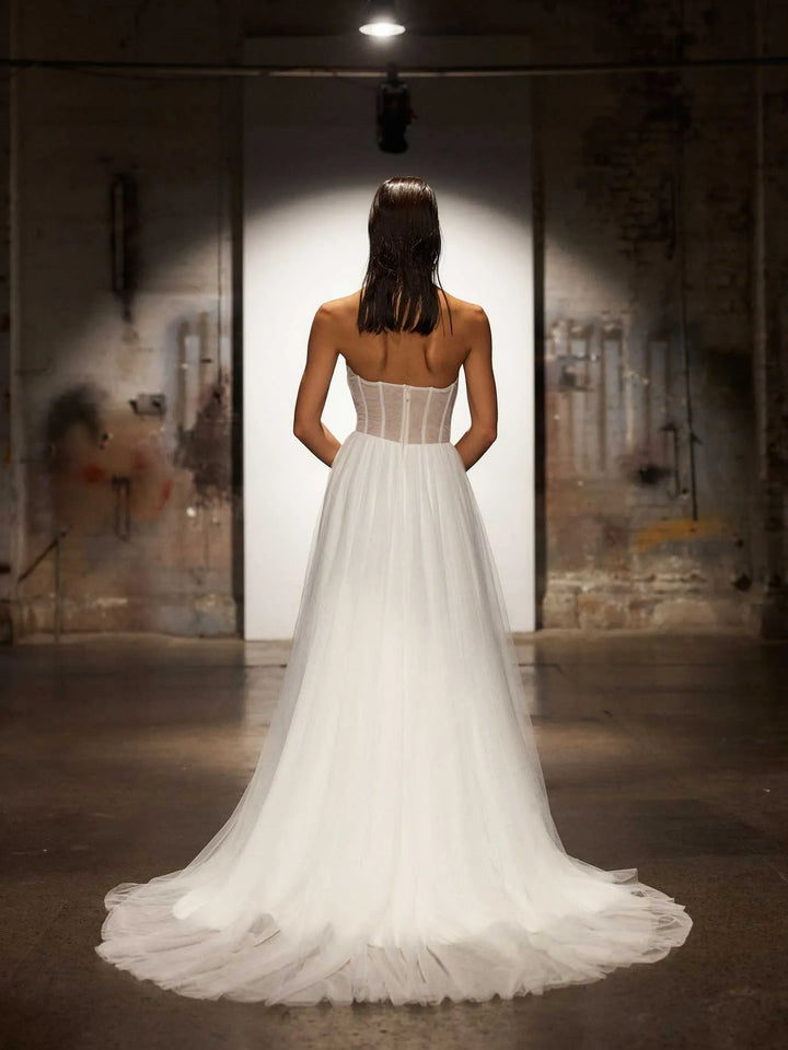 back of evie young houston tulle a-line wedding dress showing the sheer back and chapel length train