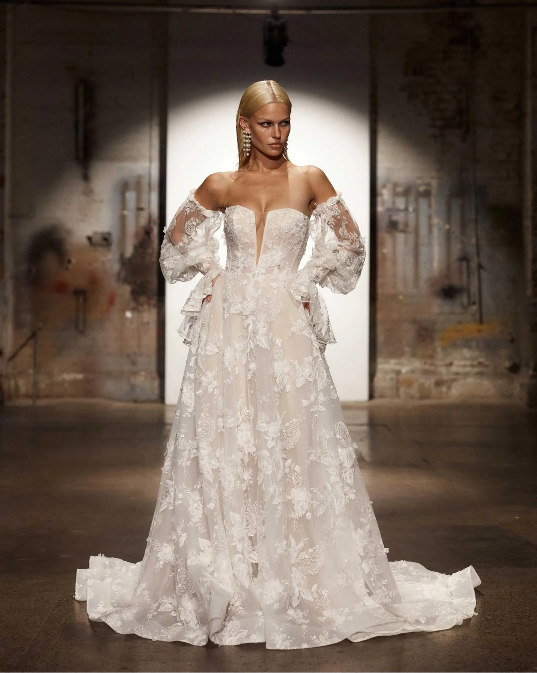 front of evie young montana ivory lace a-line wedding dress showing the plunge neckline and detached long sleeves