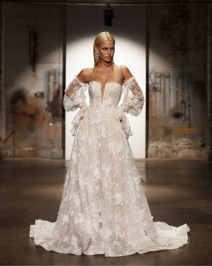 front of evie young montana ivory lace a-line wedding dress showing the plunge neckline and detached long sleeves