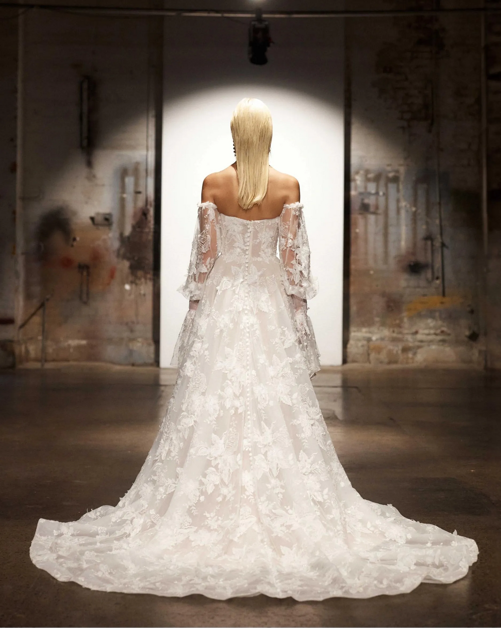 back of evie young montana ivory lace a-line wedding dress showing the chapel length train