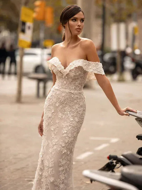 close up of giovanna alessandro charlotta blush fitted wedding dress with an off the shoulder neckline