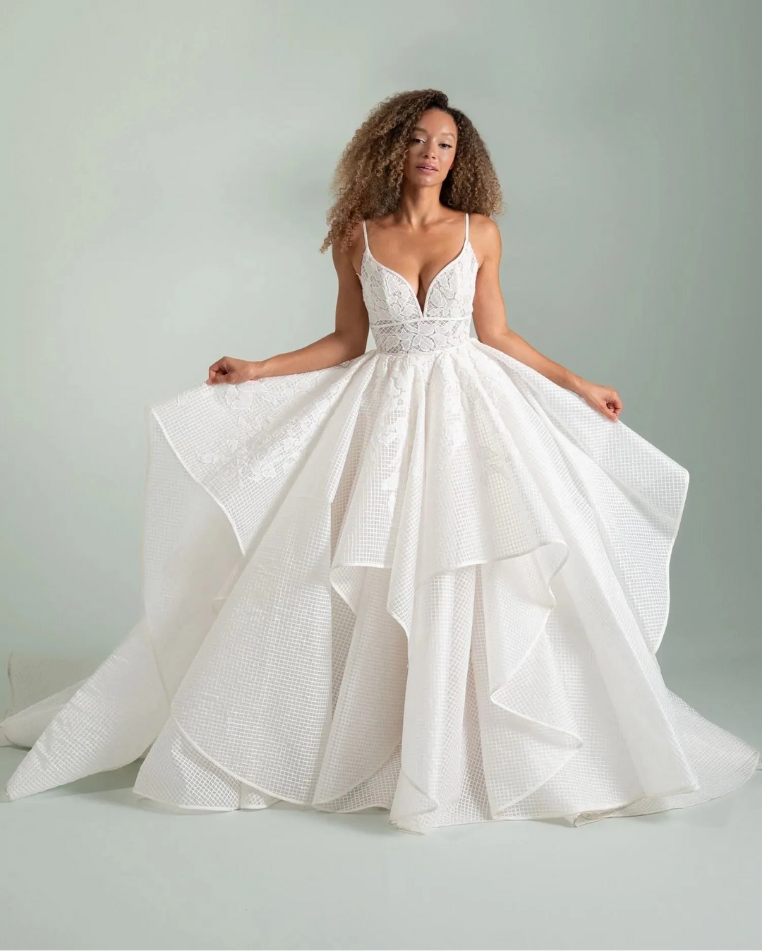Woman wearing a white wedding dress with a plain background