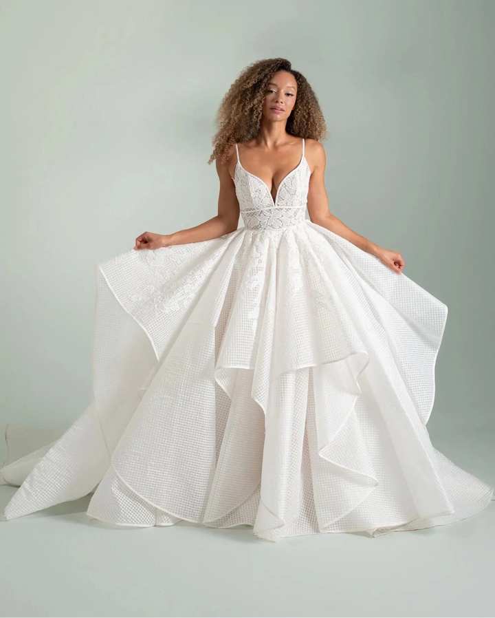 Woman wearing a white wedding dress with a plain background